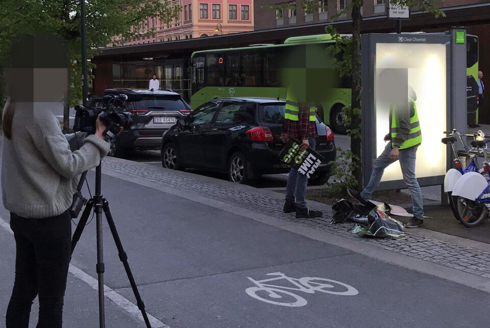 VED BUSSTERMINALEN: Her er aksjonistene i sving med å erstatte reklamen med egne verker. Det ble tilsynelatende også produsert film av det hele.