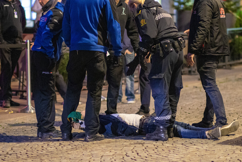 RETT UT: Mannen på bakken lagde bråk inne på en nattklubb, og satte seg opp mot dørvaktene. Her har han kapitulert, og får en håndsrekning av lovens lange arm for å komme seg på beina. Deretter bar det i arresten også for denne karen.