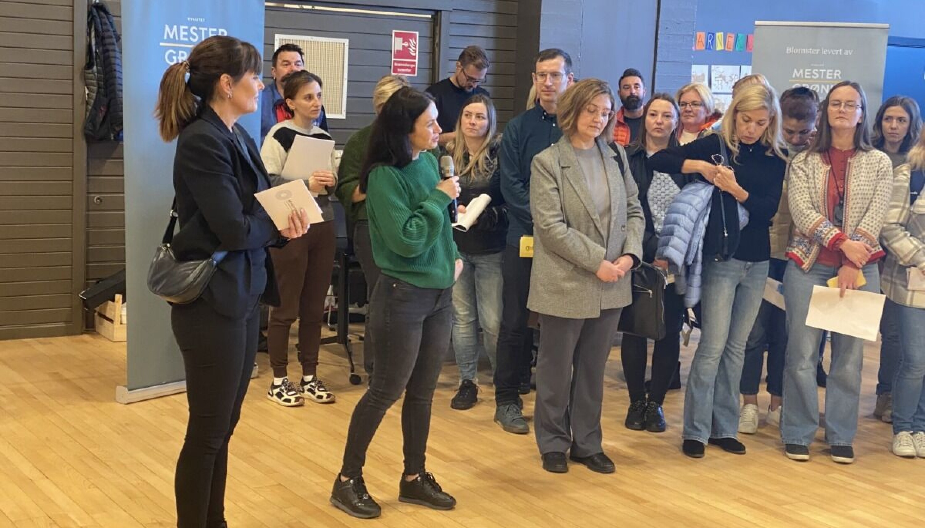 Natalia Sakhan (med mikrofon) fra NAV Drammen, er tolk når Cecilie Brunsell (t.v.) holder sitt innlegg til de fremmøtte arbeidssøkerne.