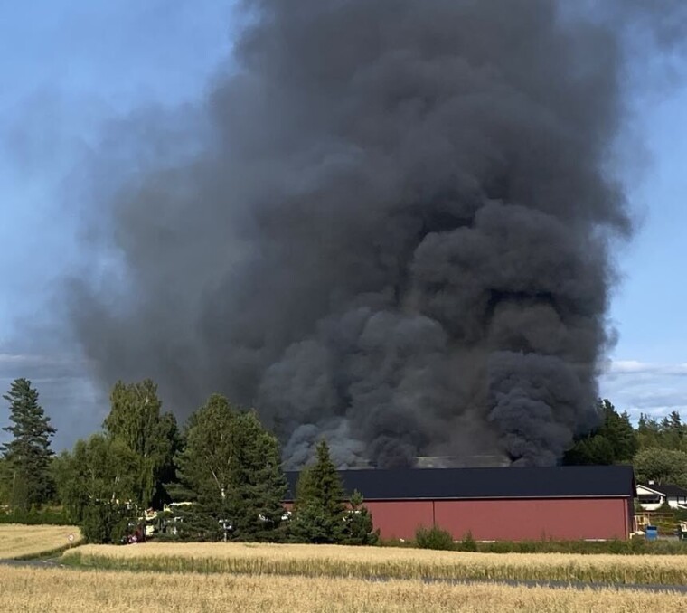 Det veltet sort røyk ut av låven som det brant voldsomt i.