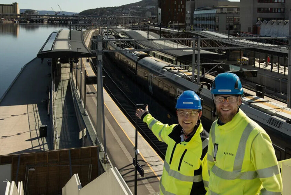 Geir Boman Rinde (til venstre) og Morten E. Paulsen er begge byggeledere for elektro på stasjonen. De viser fornøyde fram de første solcellepanelene som ble montert på plattformtaket ved elva.